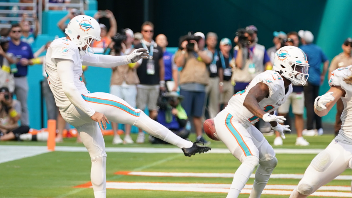 Sep 25, 2022; Miami Gardens, Florida, USA; Miami Dolphins punter Thomas Morstead (4) punts the ball into the backside of wide receiver Trent Sherfield (14) resulting in a safety for the Buffalo Bills during the second half at Hard Rock Stadium.